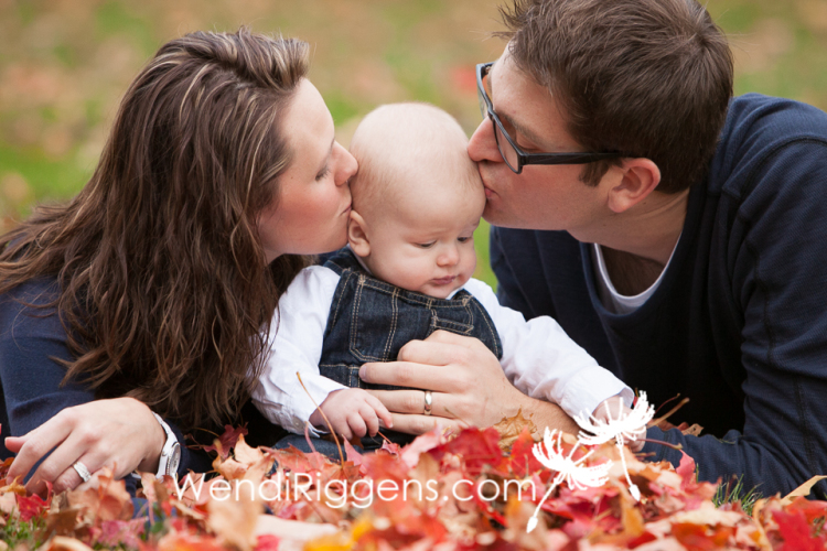 Baby and Family In The Fall Leaves